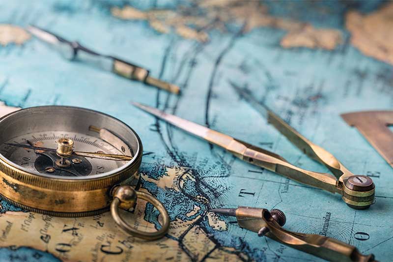 social media ad campaign agency - photo of An old geographic map with navigational tools